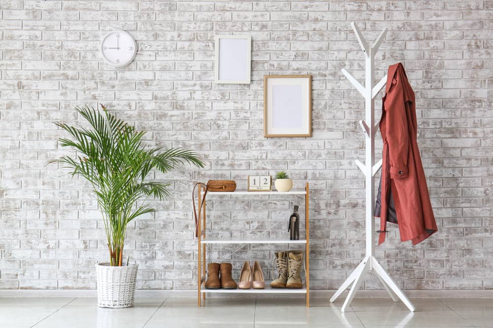 Add excitement to a stale vignette with a few well-placed plants. Here, a simple cart doubles as a plant stand and bar. "I’m always looking for ways to tuck little plants into an unexpected spot like that," Hilton says. "They make a space dynamic." Plus, the heart-shape philodendron trained around the mirror frame "really adds depth and interest," he says.