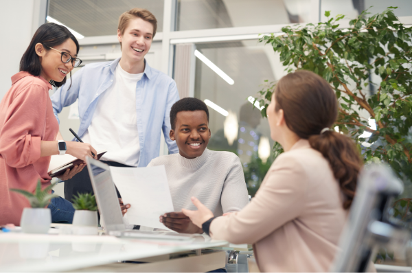 Young people having a meeting with houseplants in the background