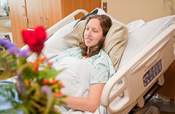 Hospital patient enjoying a flowering houseplant