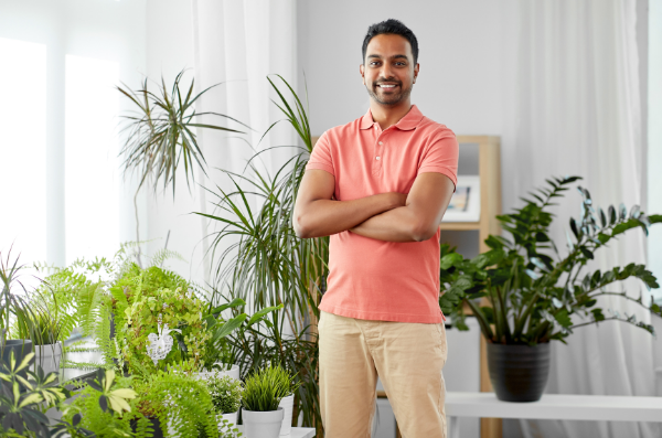 Houseplant dad with his plant babies behind