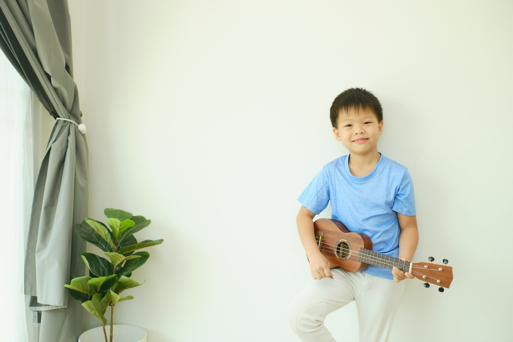 A person playing music for a plant in a garden